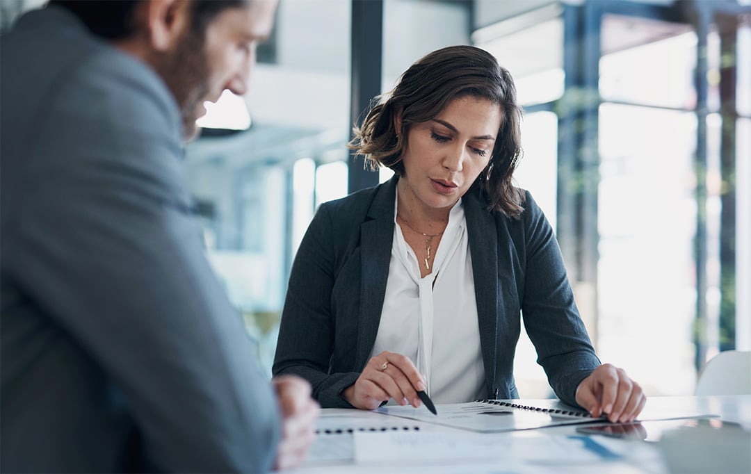 woman pointing at document in meeting