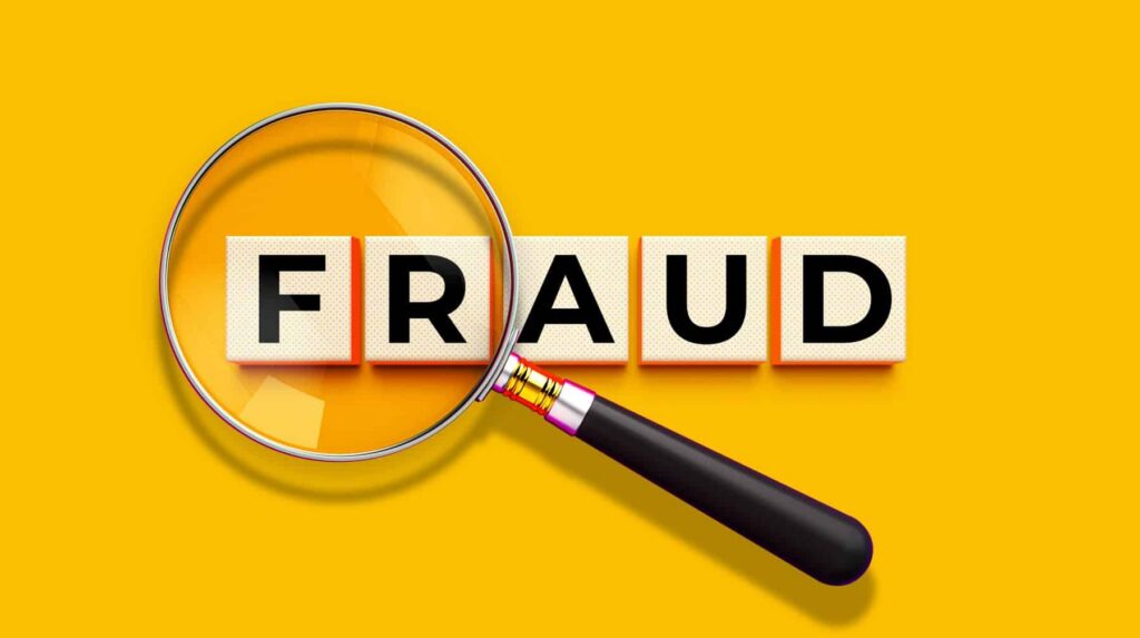 magnifying glass on fraud